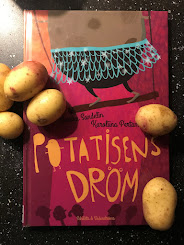 Rosa framsida, potatisar ligger på och omkring boken